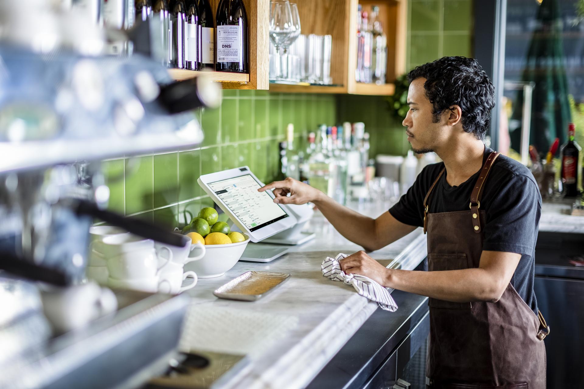 Café worker looking at Clover Station Solo
